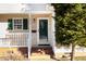 Close-up of the front entryway with a brick porch and white railing at 1614 W Cotton Gin Dr, Clayton, NC 27527