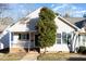 Charming home with a cozy front porch and well-maintained landscaping at 1614 W Cotton Gin Dr, Clayton, NC 27527