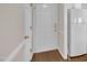 Clean, bright hallway featuring a front door, closet door, and view of the kitchen at 1614 W Cotton Gin Dr, Clayton, NC 27527