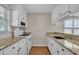 Classic kitchen features granite counters, white cabinets, and modern appliances at 1614 W Cotton Gin Dr, Clayton, NC 27527