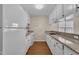 Well-lit kitchen with wooden floors, granite countertops, and white appliances at 1614 W Cotton Gin Dr, Clayton, NC 27527