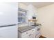 Compact kitchen featuring white cabinets, granite countertops, and modern appliances at 1614 W Cotton Gin Dr, Clayton, NC 27527
