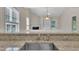 The kitchen sink offers a view of the well-lit living room and fireplace at 1614 W Cotton Gin Dr, Clayton, NC 27527