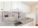 Kitchen offers granite countertops, white cabinetry, and a view to the Gathering room at 1614 W Cotton Gin Dr, Clayton, NC 27527