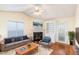 Cozy living room featuring hardwood floors, a fireplace, and built-in shelving, with access to the outdoors at 1614 W Cotton Gin Dr, Clayton, NC 27527