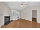 Bright living room featuring a fireplace, built-in shelving, and hardwood floors at 1614 W Cotton Gin Dr, Clayton, NC 27527