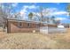 Backyard view of the home's exterior with brick siding and white railing on back deck at 1702 Nc 242 N, Benson, NC 27504