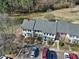 Overhead shot of the townhouse complex, featuring parking and neighboring tree-lined grounds at 174 St. Andrews Ln, Chapel Hill, NC 27517