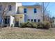Exterior view of the back of the townhouse, showcasing the lawn, landscaping, and back patio at 174 St. Andrews Ln, Chapel Hill, NC 27517