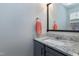 Bathroom features a granite countertop, gray cabinets, and a black-framed mirror at 174 St. Andrews Ln, Chapel Hill, NC 27517