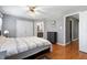 Bright bedroom featuring hardwood floors, ceiling fan, and ensuite bathroom at 174 St. Andrews Ln, Chapel Hill, NC 27517