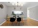 Inviting dining area featuring a modern table setting and a pass-through to the updated kitchen at 174 St. Andrews Ln, Chapel Hill, NC 27517