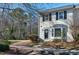 Charming townhome exterior featuring a well-manicured lawn and cozy front porch with tasteful decor at 174 St. Andrews Ln, Chapel Hill, NC 27517