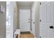 Bright foyer features a white door, coat closet, a sitting bench, and light-colored wood flooring at 174 St. Andrews Ln, Chapel Hill, NC 27517