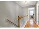 Upstairs hallway with hardwood floors and view into the bedroom at 174 St. Andrews Ln, Chapel Hill, NC 27517