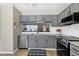 Updated kitchen featuring granite counters, stainless appliances, and a pass-through to the dining area at 174 St. Andrews Ln, Chapel Hill, NC 27517