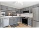 Bright kitchen featuring stainless steel appliances, granite counters, and a view to the dining room at 174 St. Andrews Ln, Chapel Hill, NC 27517
