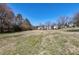 Wide angle view of the expansive green lawn and tree-lined landscape at 174 St. Andrews Ln, Chapel Hill, NC 27517