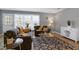 Bright living room with modern decor, hardwood floors, and large windows providing natural light at 174 St. Andrews Ln, Chapel Hill, NC 27517