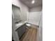 Bathroom featuring a vanity with a granite counter, shower over tub and wood-look flooring at 197 Pate Landing Dr, Selma, NC 27576