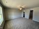 Spacious bedroom with carpet flooring, neutral walls, ceiling fan, and ample natural light at 197 Pate Landing Dr, Selma, NC 27576