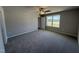 Cozy bedroom featuring carpeted floors, neutral paint, a ceiling fan, and natural light from the window at 197 Pate Landing Dr, Selma, NC 27576