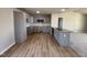 Modern kitchen with gray cabinets, granite countertops, stainless steel appliances, and wood-style floors at 197 Pate Landing Dr, Selma, NC 27576