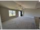Bright living room featuring neutral walls, carpeted floors, a ceiling fan, and natural light from a window at 197 Pate Landing Dr, Selma, NC 27576