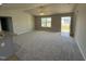 Bright living room features neutral walls, carpeted floors, a ceiling fan, and natural light from a window at 197 Pate Landing Dr, Selma, NC 27576
