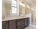 Modern bathroom featuring a double vanity, quartz countertops, and tiled shower with a glass door at 205 Big Bradley Dr, Wendell, NC 27591