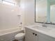Well-lit bathroom featuring a bathtub with shower and single sink vanity at 205 Big Bradley Dr, Wendell, NC 27591