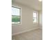 Bright bedroom featuring two large windows that offer views of the outdoors at 205 Big Bradley Dr, Wendell, NC 27591
