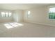 Large bonus room featuring a carpet floor and multiple windows for ample natural light at 205 Big Bradley Dr, Wendell, NC 27591