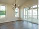 Dining room featuring hardwood flooring, a modern chandelier, and access to a screened porch at 205 Big Bradley Dr, Wendell, NC 27591