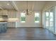 Dining room featuring hardwood floors, modern chandelier, and direct access to the kitchen at 205 Big Bradley Dr, Wendell, NC 27591