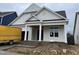 New construction exterior showing front entrance with stone steps and neutral siding at 205 Big Bradley Dr, Wendell, NC 27591