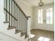Foyer showcasing wood stairs, black railings and double doors with glass at 205 Big Bradley Dr, Wendell, NC 27591