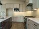 Kitchen features modern appliances, a large island with sink and decorative tile backsplash at 205 Big Bradley Dr, Wendell, NC 27591