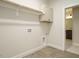 Functional laundry area featuring a hanging rod, a utility sink and tile flooring at 205 Big Bradley Dr, Wendell, NC 27591
