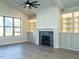 A living room features built-in shelving, a fireplace and a large window at 205 Big Bradley Dr, Wendell, NC 27591