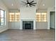 Living room with fireplace, built-in cabinets, and a ceiling fan at 205 Big Bradley Dr, Wendell, NC 27591
