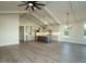 Open concept view of the kitchen and living room with vaulted ceilings and hardwood floors at 205 Big Bradley Dr, Wendell, NC 27591