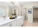 Bright bathroom features a double vanity, large mirror, and separate toilet room at 211 Whitney Ln, Durham, NC 27713