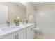 Bright bathroom boasts double sinks, white cabinets, and a shower-tub combination at 211 Whitney Ln, Durham, NC 27713