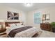 Cozy bedroom featuring a wood headboard, dresser, and natural light from the window at 211 Whitney Ln, Durham, NC 27713