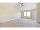 Large bedroom features neutral carpet, a window, and has a door leading to the hall at 211 Whitney Ln, Durham, NC 27713