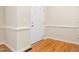 Bright foyer area showcasing hardwood flooring, neutral walls and white trim at 211 Whitney Ln, Durham, NC 27713