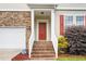 Inviting brick steps lead to the front door and covered porch entrance at 211 Whitney Ln, Durham, NC 27713