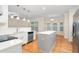 Open kitchen boasts stainless steel appliances and white countertops and opens to dining area at 211 Whitney Ln, Durham, NC 27713