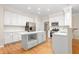 Spacious kitchen featuring white cabinetry, an island, and modern stainless steel appliances at 211 Whitney Ln, Durham, NC 27713